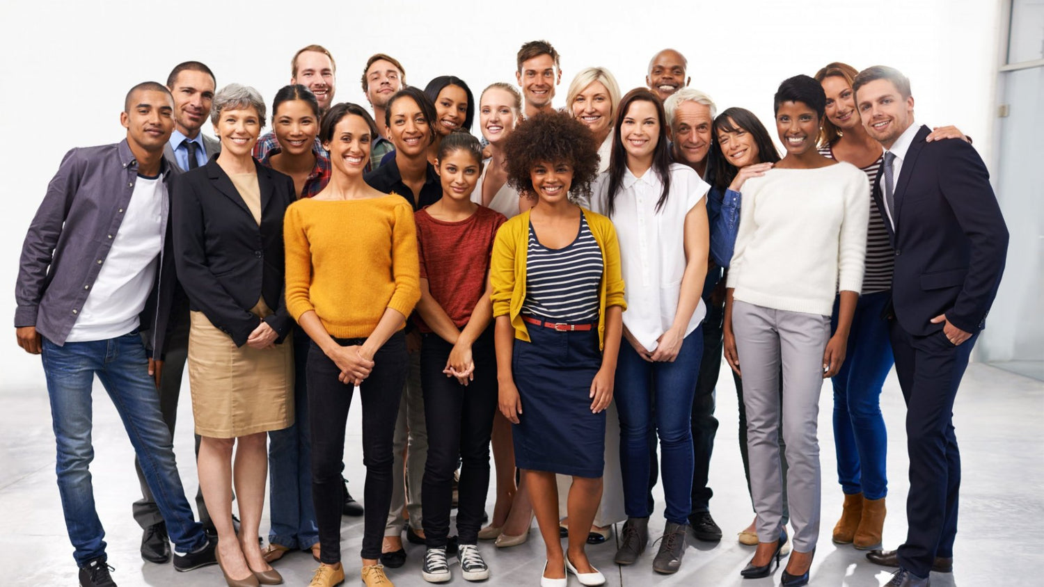 A diverse group of people containing different ages, genders, and races.